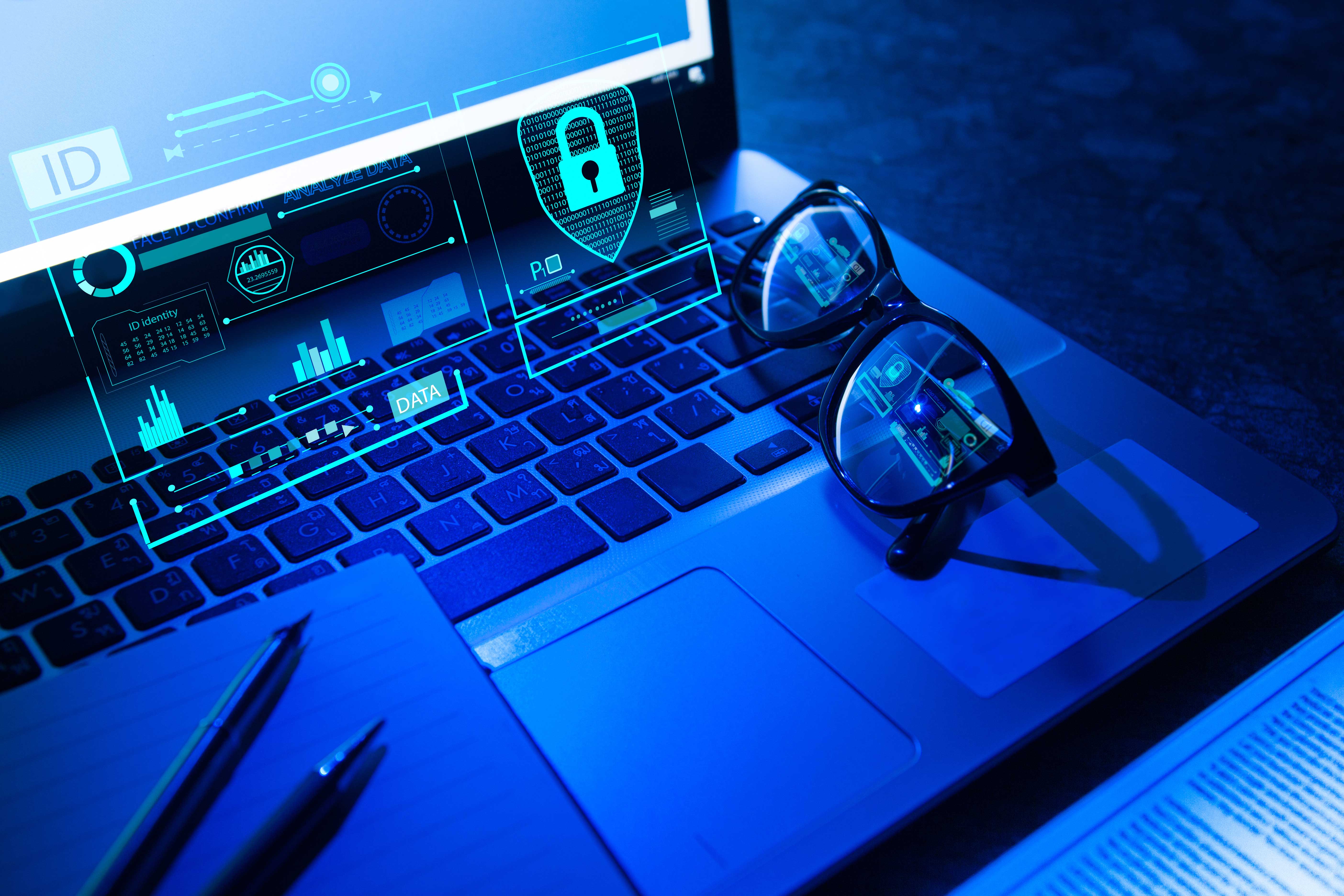 Close up view of laptop keypad with black eyeglasses on it