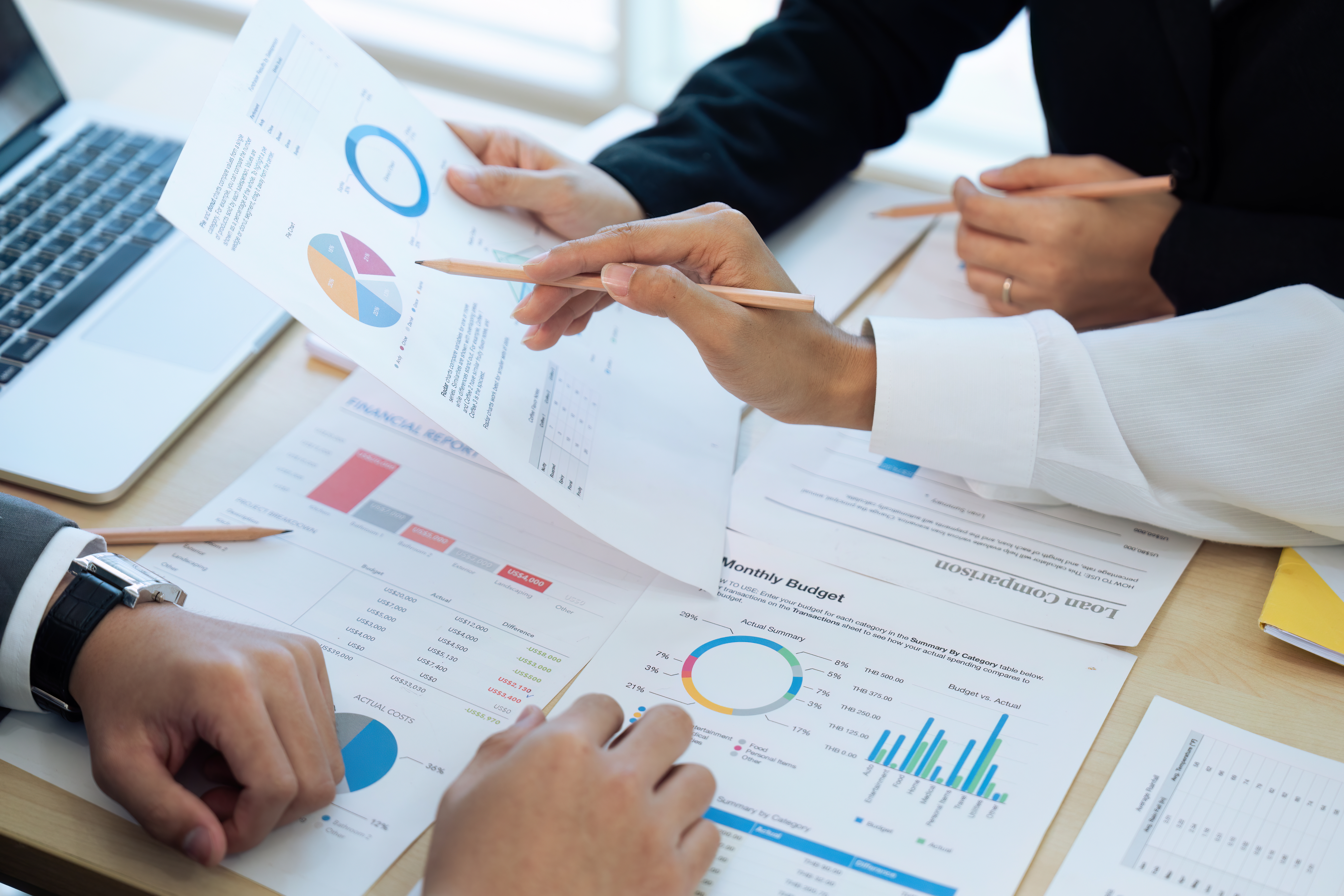 Close-up view of people working in the office, holding reports, discussing to one another